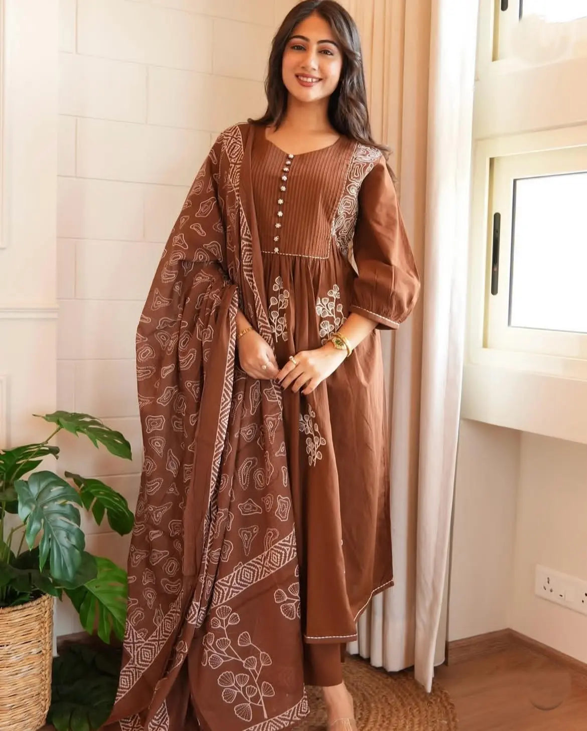Model twirling flared cotton Anarkali suit with dupatta