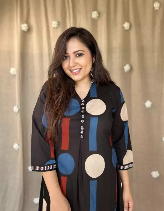 Elegant polka dot printed black co-ord set with a flowy kurti and straight pants, perfect for casual and festive looks.