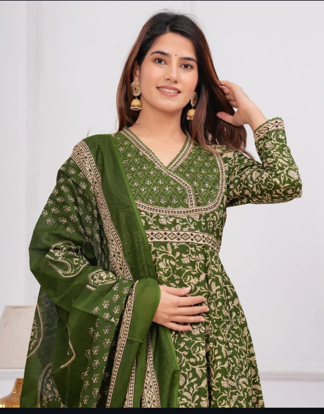 Exquisite green Anarkali suit with intricate embroidery, crafted from soft cotton for festive and casual wear.