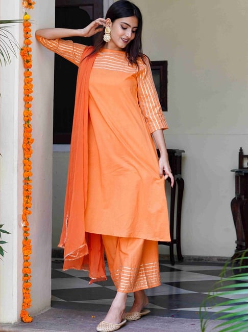 Elegant orange kurti with intricate gota lace work, styled with matching pants and a dupatta for traditional celebrations.