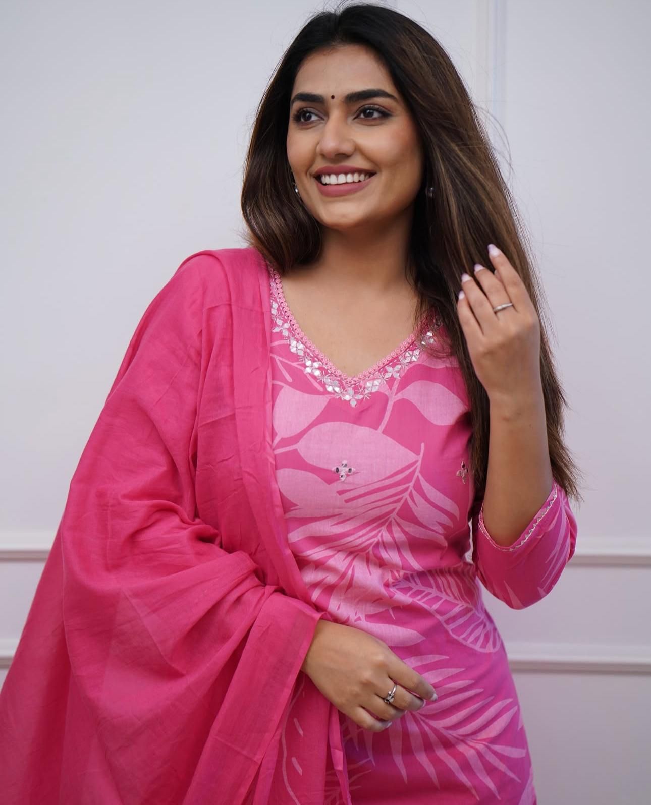 Soft muslin pink kurti with subtle sequin detailing, styled with straight pants and a dupatta for a graceful festive outfit.