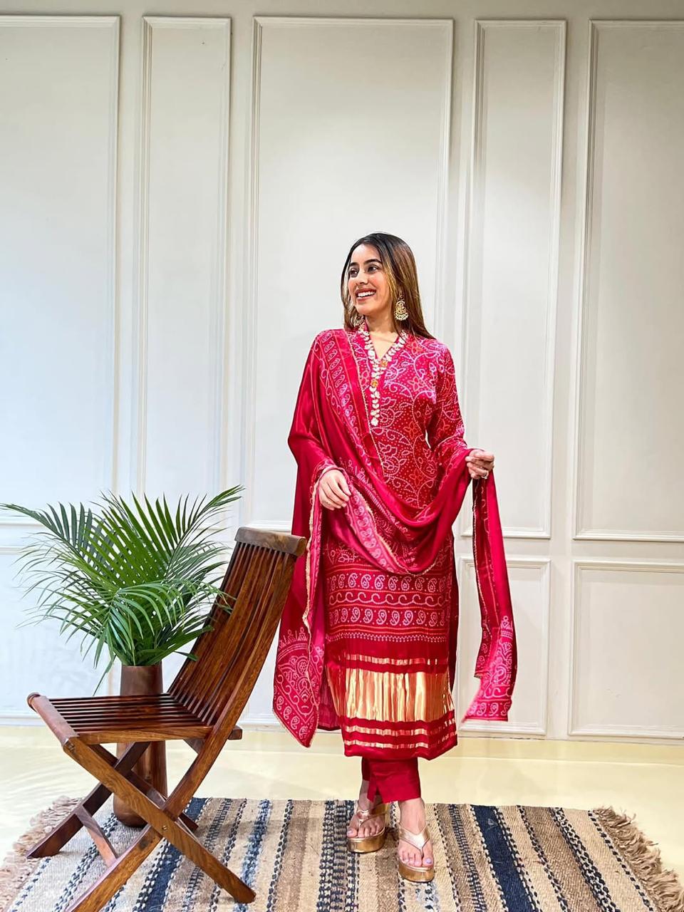 Red Chinon straight-fit suit set with zari embroidery, matching pants, and a dupatta, perfect for festive and wedding occasions.