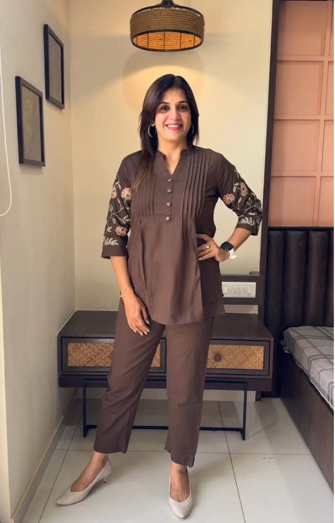 Full co-ord set laid flat, highlighting the detailed embroidery and button work.