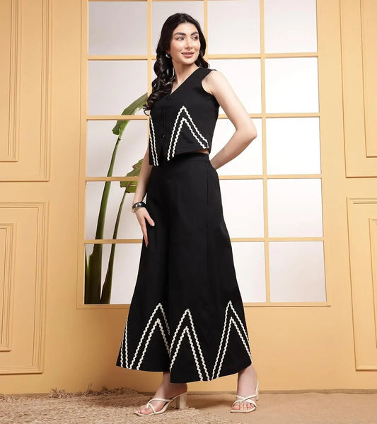 Black sleeveless co-ord set with white zigzag lace details