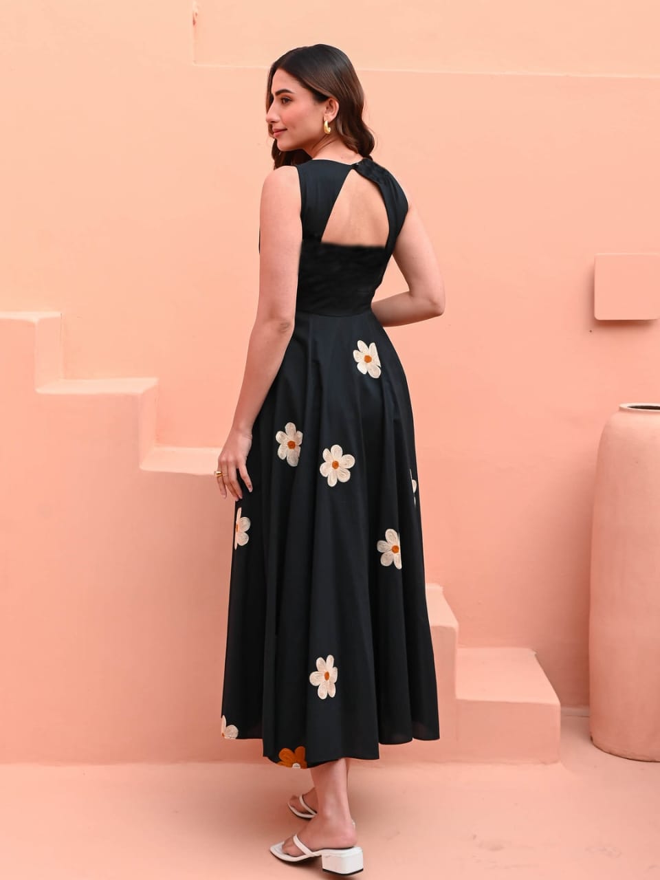 Model wearing embroidered black cotton dress for café look