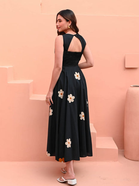 Model wearing embroidered black cotton dress for café look
