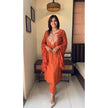 Model styling the rust orange chikankari suit with jhumkas

