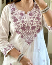 Close-up of neckline embroidery on white kurti

