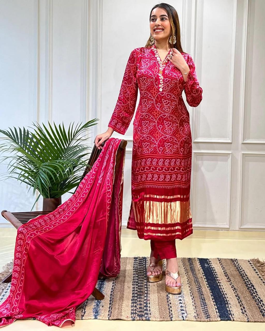Red Chinon straight-fit suit set with zari embroidery, matching pants, and a dupatta, perfect for festive and wedding occasions.