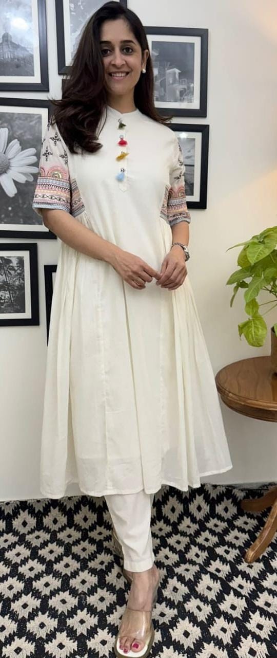 Front view of model wearing sequin embroidered A-line kurta set

