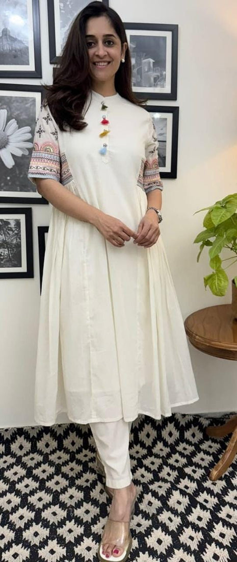 Front view of model wearing sequin embroidered A-line kurta set

