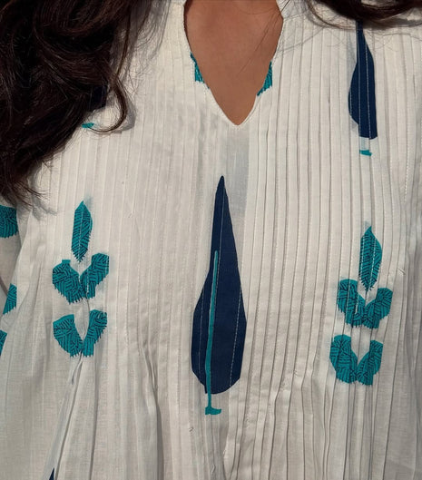 Close-up of pintex detailing on yoke and soft fabric texture

