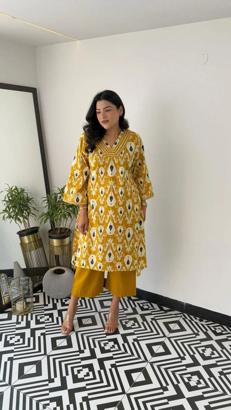 Yellow embroidered cotton kurti set with lace detailing on the neckline

